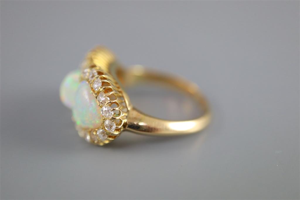 A gold, three stone white opal and diamond set cluster ring,